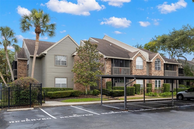 2500 Winding Creek Blvd Unit A104, Clearwater, FL 33761 - view of building exterior with covered and uncovered parking and fence