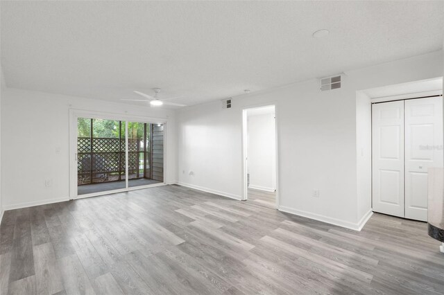 2500 Winding Creek Blvd Unit A104, Clearwater, FL 33761 - unfurnished living room with wood finished floors, a ceiling fan, and baseboards