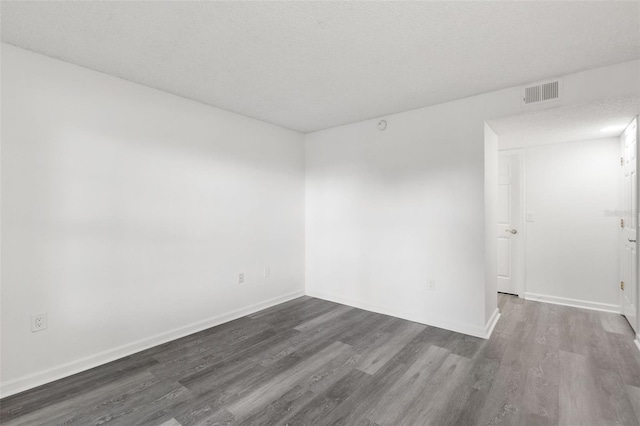 2500 Winding Creek Blvd Unit A104, Clearwater, FL 33761 - spare room featuring dark wood-type flooring and baseboards