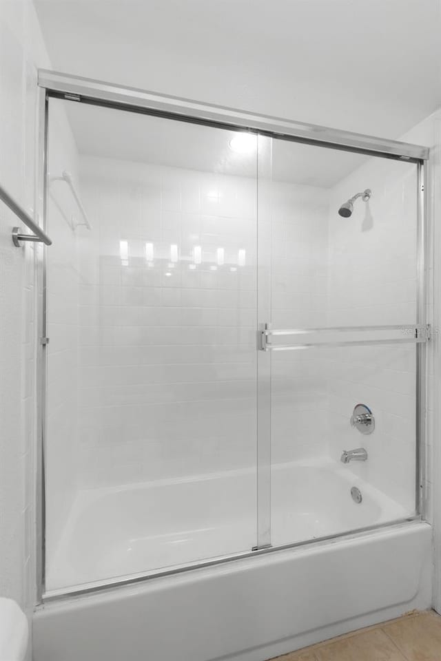 2500 Winding Creek Blvd Unit A104, Clearwater, FL 33761 - bathroom featuring tile patterned flooring and combined bath / shower with glass door