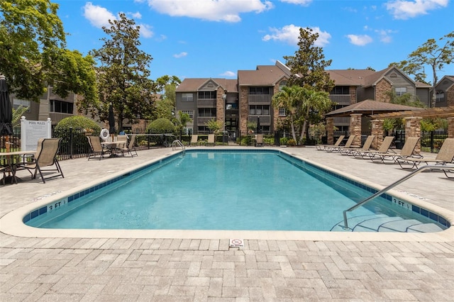 2500 Winding Creek Blvd Unit A104, Clearwater, FL 33761 - community pool with fence, a patio area, and a residential view
