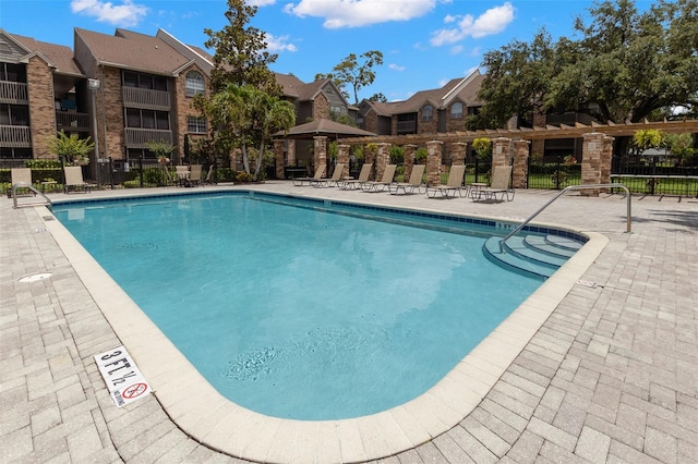 2500 Winding Creek Blvd Unit A104, Clearwater, FL 33761 - community pool with fence, a patio, and a residential view