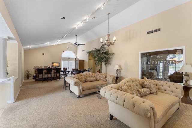 2500 Winding Creek Blvd Unit A104, Clearwater, FL 33761 - living area with track lighting, a chandelier, plenty of natural light, light colored carpet, and high vaulted ceiling