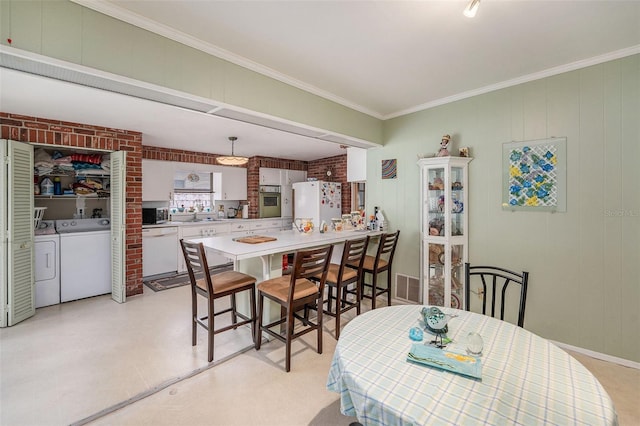 5250 12th St N, Saint Petersburg, FL 33703 - dining room with ornamental molding and separate washer and dryer