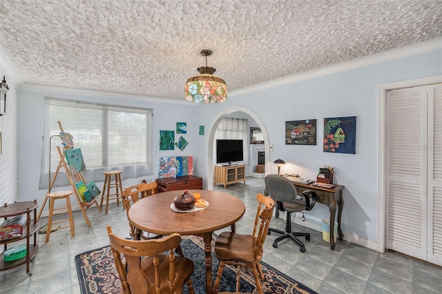 5250 12th St N, Saint Petersburg, FL 33703 - dining space with arched walkways, an office area, and a textured ceiling