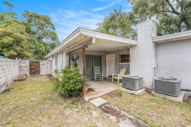 5250 12th St N, Saint Petersburg, FL 33703 - rear view of house featuring a gate, cooling unit, a chimney, and a fenced backyard