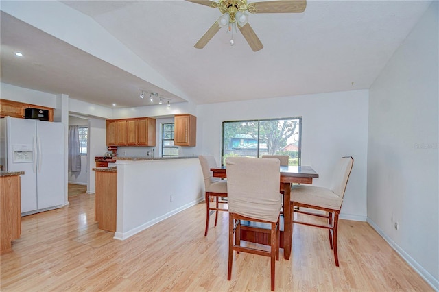 4911 Country Aire Ln, Tampa, FL 33624 - dining area featuring vaulted ceiling, light wood-style flooring, a ceiling fan, and baseboards