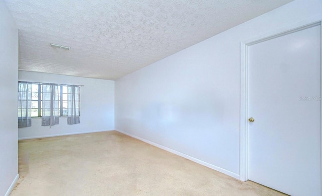 4911 Country Aire Ln, Tampa, FL 33624 - spare room with light carpet, a textured ceiling, and baseboards