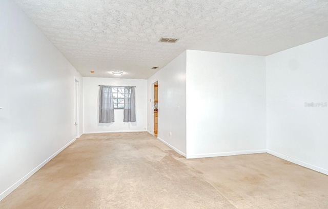 4911 Country Aire Ln, Tampa, FL 33624 - empty room with baseboards, a textured ceiling, and light colored carpet