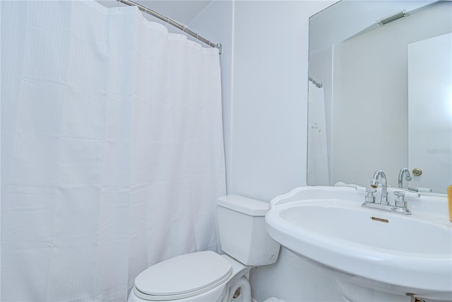 4911 Country Aire Ln, Tampa, FL 33624 - bathroom with toilet, a sink, and curtained shower