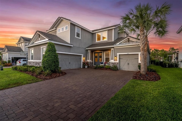 3850 Bonfire Dr, Odessa, FL 33556 - view of front facade featuring stone siding, decorative driveway, stucco siding, and a lawn