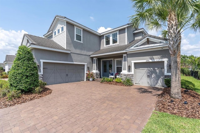3850 Bonfire Dr, Odessa, FL 33556 - view of front of home with stucco siding, decorative driveway, and stone siding