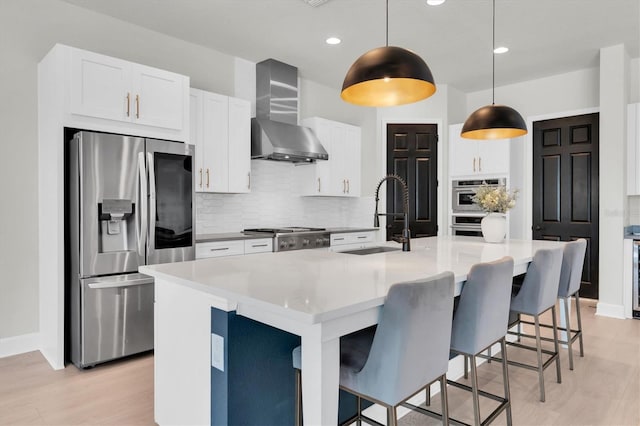 3850 Bonfire Dr, Odessa, FL 33556 - kitchen featuring stainless steel fridge with ice dispenser, a sink, wall chimney range hood, tasteful backsplash, and light wood-type flooring