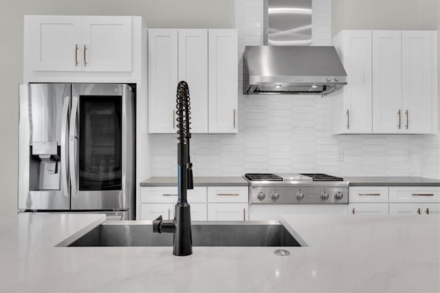 3850 Bonfire Dr, Odessa, FL 33556 - kitchen featuring appliances with stainless steel finishes, wall chimney exhaust hood, and white cabinets