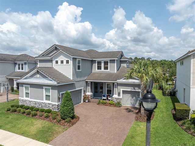 3850 Bonfire Dr, Odessa, FL 33556 - view of front of property featuring a tile roof, stucco siding, decorative driveway, stone siding, and a front yard