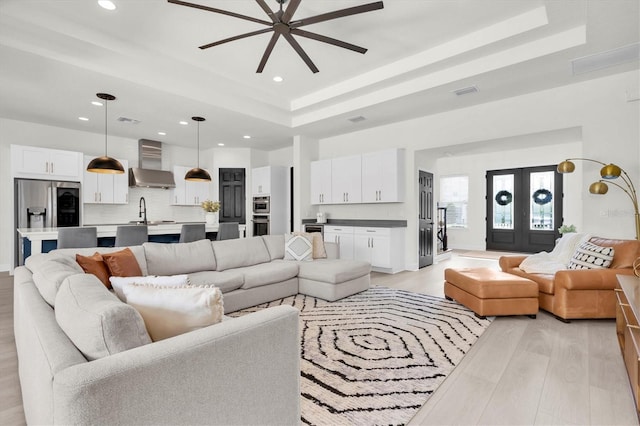 3850 Bonfire Dr, Odessa, FL 33556 - living area with a tray ceiling, a ceiling fan, light wood finished floors, and recessed lighting