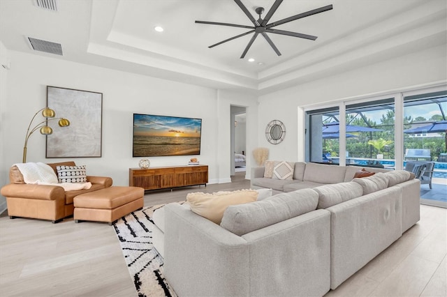 3850 Bonfire Dr, Odessa, FL 33556 - living room with a tray ceiling, a ceiling fan, light wood-style flooring, and recessed lighting