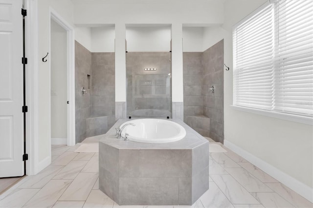 3850 Bonfire Dr, Odessa, FL 33556 - full bath with marble look tile flooring, a bath, walk in shower, and baseboards