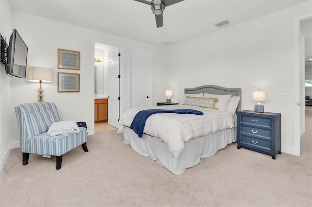3850 Bonfire Dr, Odessa, FL 33556 - bedroom featuring light colored carpet, baseboards, connected bathroom, and a ceiling fan