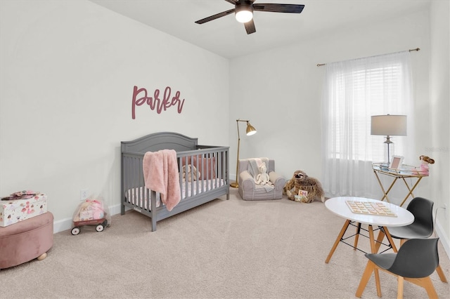 3850 Bonfire Dr, Odessa, FL 33556 - carpeted bedroom featuring a crib, a ceiling fan, and baseboards