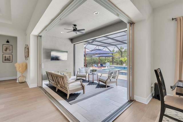 3850 Bonfire Dr, Odessa, FL 33556 - living room with a sunroom, a ceiling fan, light wood-type flooring, baseboards, and recessed lighting