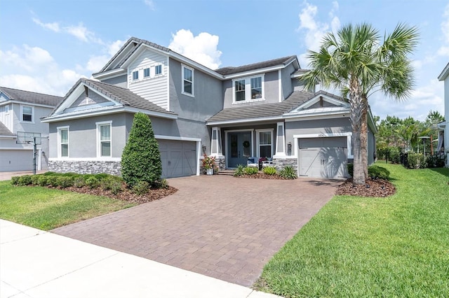 3850 Bonfire Dr, Odessa, FL 33556 - view of front facade with a front lawn, decorative driveway, stone siding, and stucco siding