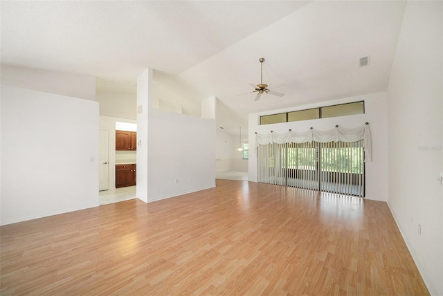 13819 Stoneridge Dr, Hudson, FL 34669 - empty room with high vaulted ceiling, ceiling fan, light wood finished floors, and baseboards