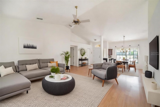 13819 Stoneridge Dr, Hudson, FL 34669 - living room featuring light wood-style flooring, a ceiling fan, a chandelier, and lofted ceiling