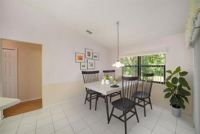 13819 Stoneridge Dr, Hudson, FL 34669 - dining space featuring vaulted ceiling, baseboards, and light tile patterned floors