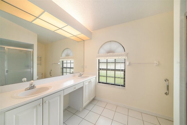 13819 Stoneridge Dr, Hudson, FL 34669 - bathroom featuring a stall shower, double vanity, tile patterned floors, and baseboards