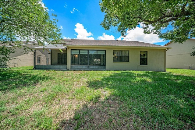 13819 Stoneridge Dr, Hudson, FL 34669 - back of house with a lawn, stucco siding, and a sunroom