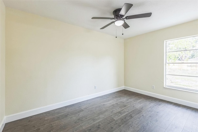 spare room featuring dark wood-style floors, baseboards, and ceiling fan