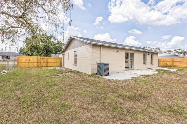 rear view of house featuring central air condition unit and a patio