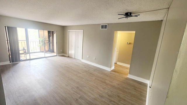 2205 Belleair Rd Unit A36, Clearwater, FL 33764 - spare room featuring light wood finished floors, a textured ceiling, baseboards, and a ceiling fan