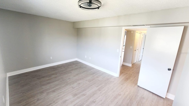 2205 Belleair Rd Unit A36, Clearwater, FL 33764 - spare room featuring wood finished floors and baseboards