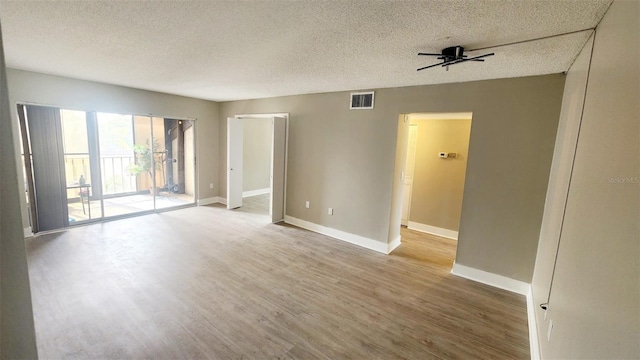 2205 Belleair Rd Unit A36, Clearwater, FL 33764 - unfurnished room with wood finished floors, a textured ceiling, baseboards, and a ceiling fan