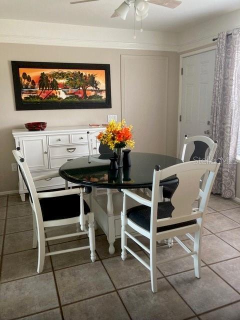 556 Virginia St, Dunedin, FL 34698 - dining area with ceiling fan and light tile patterned floors