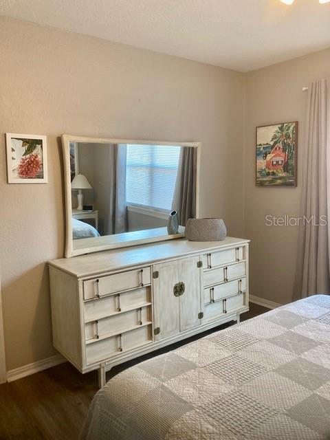 556 Virginia St, Dunedin, FL 34698 - bedroom featuring baseboards and dark wood-type flooring