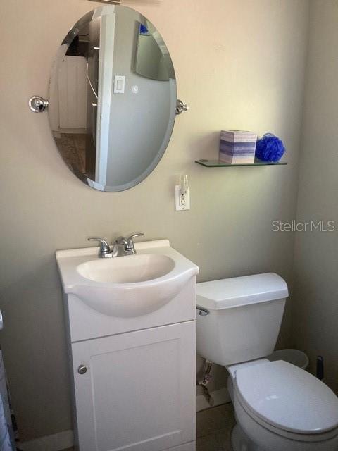 556 Virginia St, Dunedin, FL 34698 - half bathroom with vanity and toilet