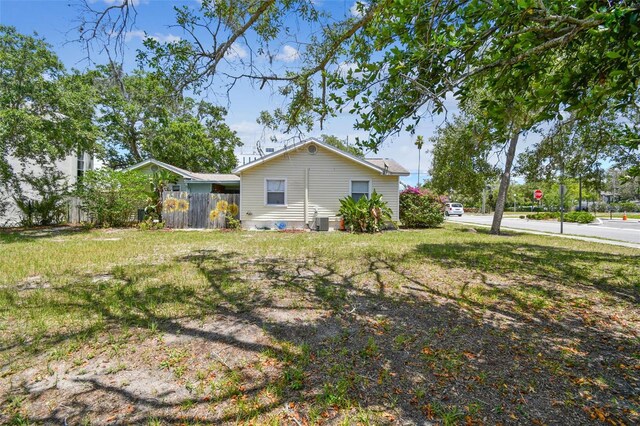556 Virginia St, Dunedin, FL 34698 - view of home's exterior with central AC unit and fence