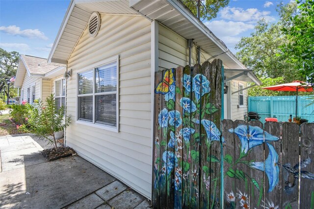 556 Virginia St, Dunedin, FL 34698 - view of home's exterior featuring fence and a patio area