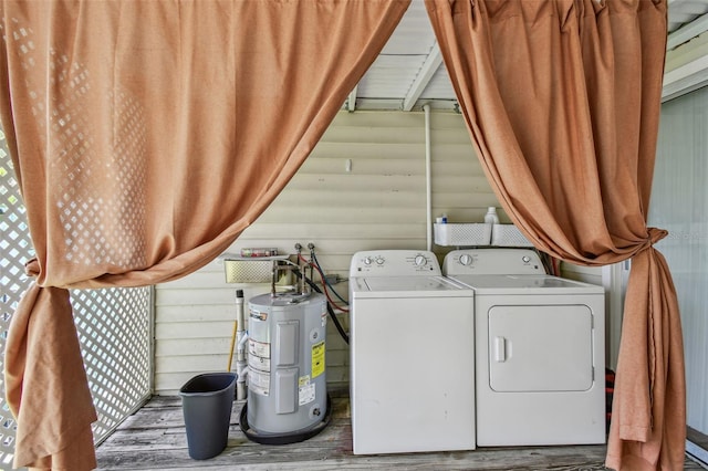 556 Virginia St, Dunedin, FL 34698 - washroom featuring electric water heater, washing machine and dryer, and wood finished floors