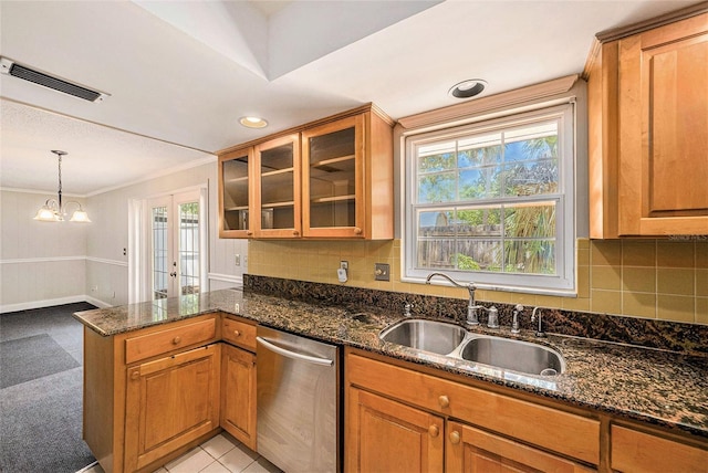 kitchen with stainless steel dishwasher, a sink, ornamental molding, a peninsula, and glass insert cabinets