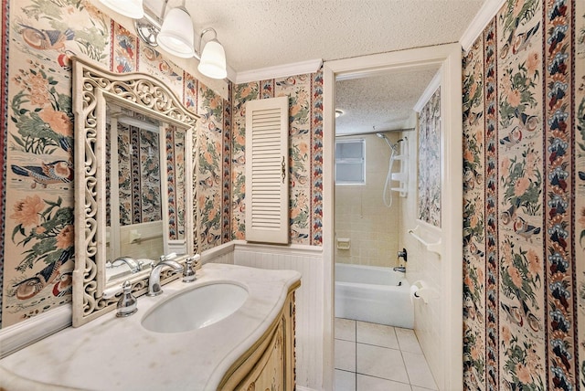 full bath with a textured ceiling, wallpapered walls, tile patterned flooring, a wainscoted wall, and vanity