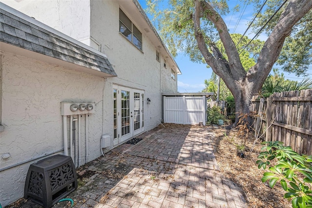 view of patio with french doors and a fenced backyard