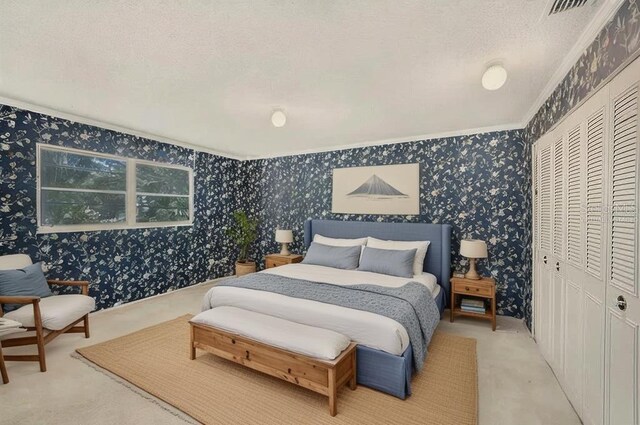 202 Mindy Dr, Largo, FL 33771 - carpeted bedroom with wallpapered walls, a closet, ornamental molding, and a textured ceiling