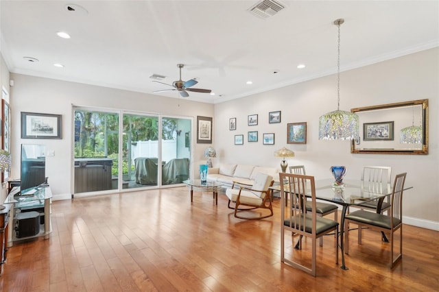 dining space with ornamental molding, ceiling fan, wood finished floors, recessed lighting, and baseboards