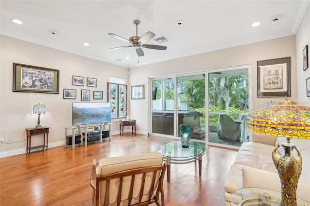 living room featuring ceiling fan, light wood-style flooring, ornamental molding, baseboards, and recessed lighting
