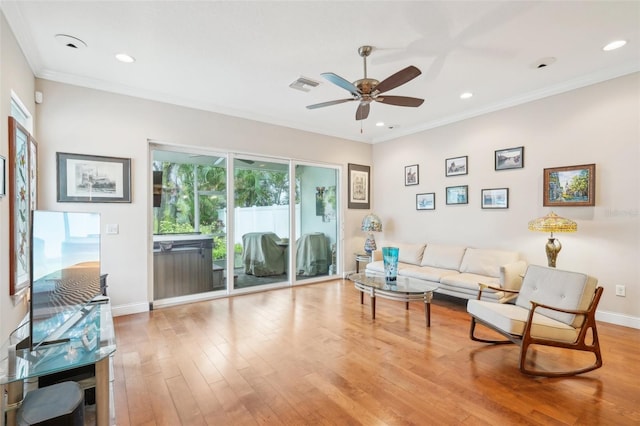 living room featuring ceiling fan, wood finished floors, ornamental molding, baseboards, and recessed lighting