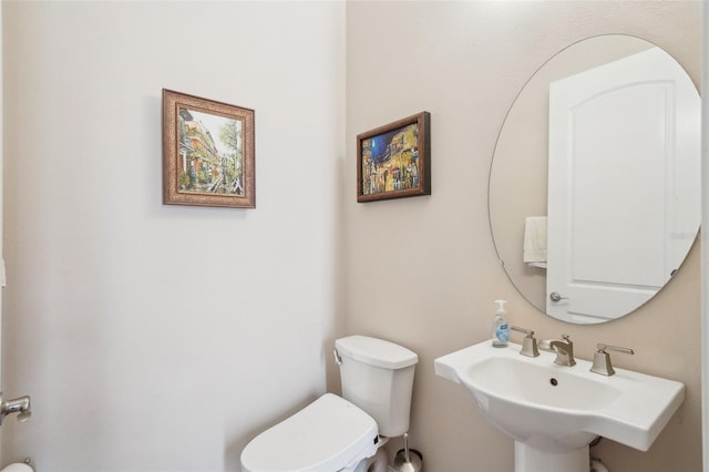 bathroom with toilet and a sink